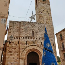 Romanesque church Sant Francesc in Montblanc with a typical blue Christmas tree
